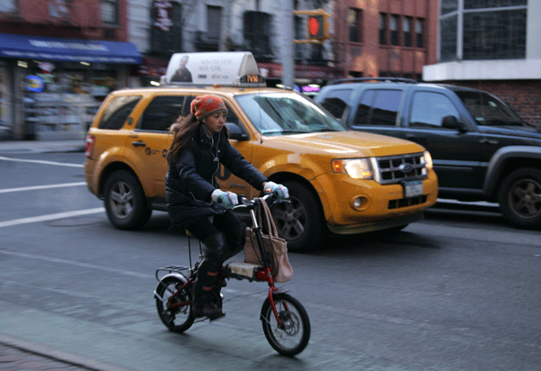 A cyclist traveled alongside vehicular traffic in the Prince St. bike lane near Sullivan St.   Photo by Sam Spokony