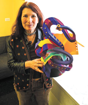 Photo by Tequila Minsky Longtime volunteer Sami Shub displayed a hat/paper sculpture entitled, “Disguise by Margo Mead.” 