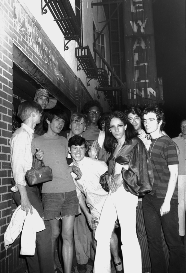 Courtesy of Steven Kasher Gallery, NY Fred W. McDarrah (1926-2007): “Celebration After Riots Outside Stonewall Inn, Nelly (Betsy Mae Koolo), Chris (Drag Queen Chris), Roger Davis, Michelle and Tommy Lanigan-Schmidt.” (RC Print, 1969. 8 1/2 x 5 1/2 inches).