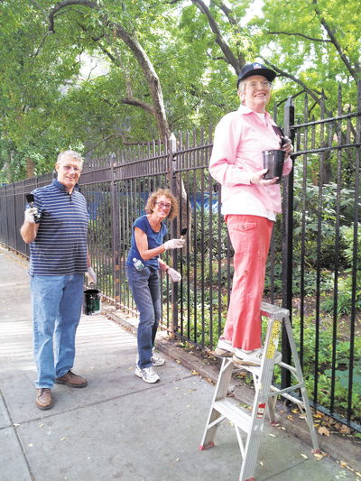 Photo by Allen Oster L to R: Longtime 22nd St. residents Robert Edgar and Lynn Weinstein, along with W. 400 Block Assoc. president Mary Swartz, were among those who answered the call to spruce up Clement Clarke Moore Park’s fence.