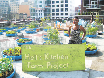 Photo by Eileen Stukane Hell’s Kitchen Farm Project coordinator Lauren Baccus, on the roof of Metro Baptist Church.