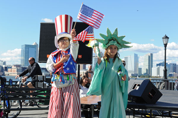 Downtown Express photos by Terese Loeb Kreuzer. Top, the New American Youth Ballet at the B.P.C. Block Party Sept. 28, the Seniors’ Chorus, and a pair of stiltwalkers. 