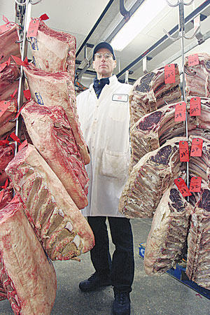 Photo by Jefferson Siegel John Jobbagy in his well-stocked refrigerated meat locker.