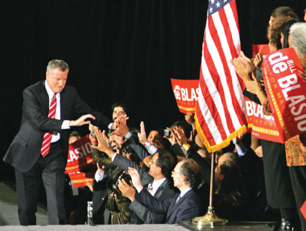 Bill de Blasio greeted jubilant supporters as he took the stage to declare victory on Tuesday night.  Downtown Express photo by Sam Spokony 