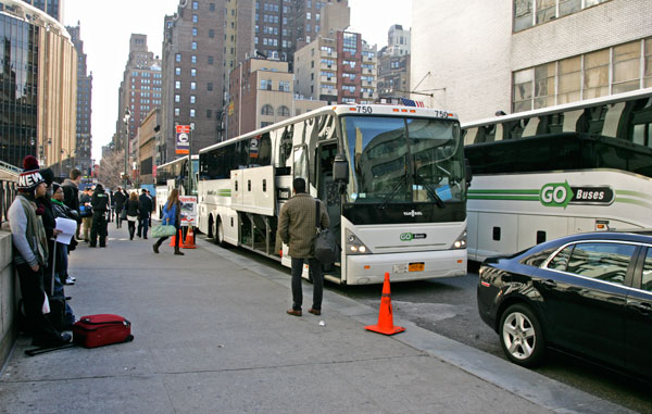 Photo by Sam Spokony Three Go Buses cram into the 70-foot terminal on W. 31st St., near Eighth Ave., on the morning of Nov. 30. A DOT proposal would place an additional intercity bus company at that site.