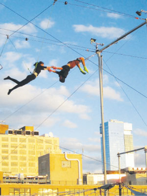 Downtown Express photo by Lincoln Anderson Trapeze swingers on top of Pier 40, just across from the St. John’s Center Building.   