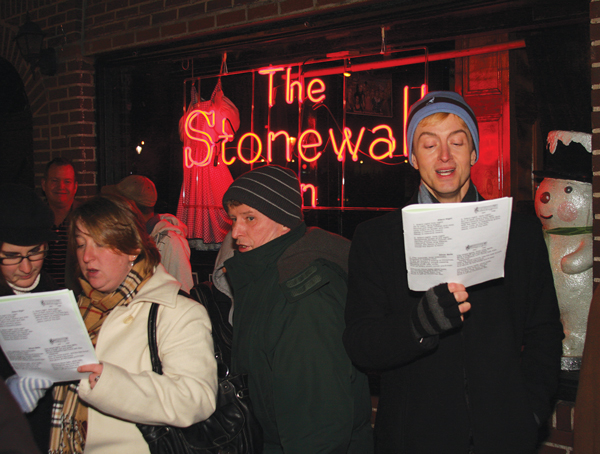 One in six (at the least) will stop by Stonewall, when groups of singers fan out across the area, for Dec. 21’s Greenwich Village Caroling Walk.  PHOTO BY WAYNE VALZANIA