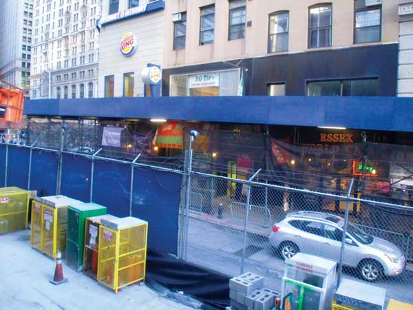 This scaffolding, which has hurt businesses across from the World Trade Center is expected to be taken down next month.     Downtown Express photo by Josh Rogers