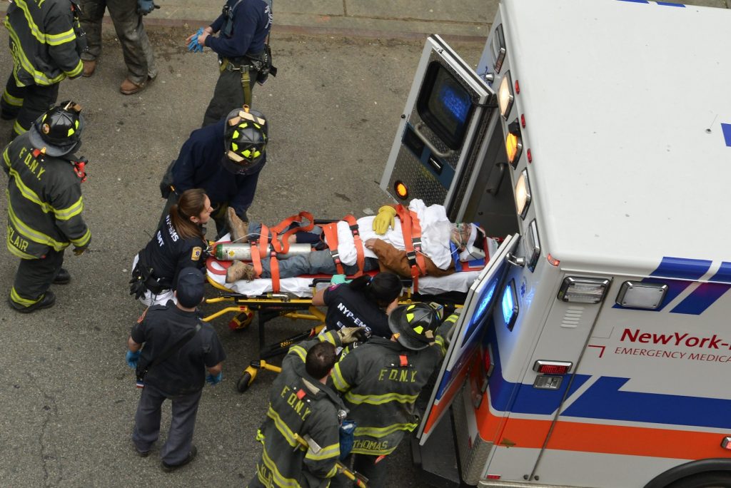 A man who fell at the God's Love We Deliver project site, at Spring St. and Sixth Ave., last Thursday is loaded into an ambulance. He was taken to Bellevue Hospital. The next day a partial stop-work order was issued for the work site.  Photo by Harry Pincus