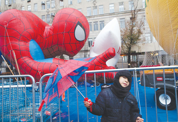 As the Thanksgiving Parade balloons were being inflated some blocks north of 14th St., a Spidey fan showed his colors.  Photo by Q. Sakamaki