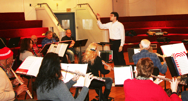 Brandon Tesh, standing, directs the New Horizons band.  Photo by Michael Lydon 