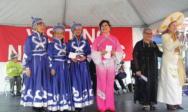 Courtesy of Visiting Neighbors A Mongolian folk dance troupe (in blue) earned second place, in the Senior Talent Show. In pink: First Prize winner Li Yana.