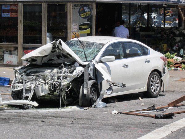 The out-of-control driver’s car that struck Mohammed Akkas Ali and two other deli employees last June 19 sat in a wreck near the store hours after the crash.    file photo