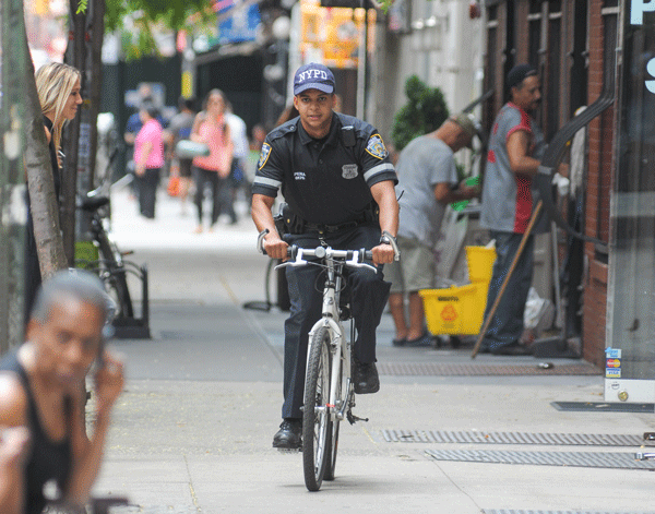 Wheels of justice turn in Nolita? Hey! Someone give that guy a ticket! A bike-patrol police officer was caught riding his official police Trek bike on the sidewalk in on Mott St. between Prince and Spring Sts. It’s great to see police on bicycles — but does this mean no one else will get tickets when they pedal on the pavement? Photo by Jason B. Nicholas