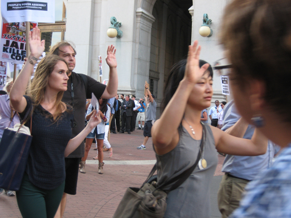 Downtown Express photo by Dusica Sue Malesevic The demonstrators marched with their hands held up in surrender. Witnesses say Michael Brown had held up his hands before he was fatally shot by a Ferguson police officer. 