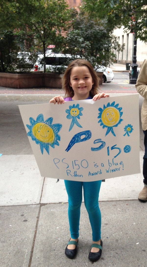 A P.S. 150 student shows her pride with a poster. Photo courtesy of Wendy Chapman.