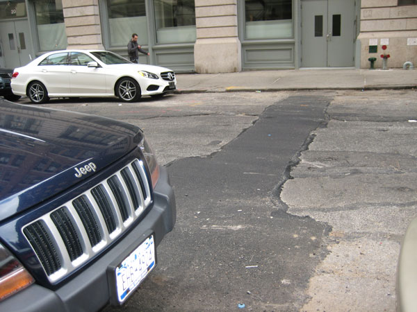 The last asphalt paving of the block between Varick and Hudson Sts. was about five years ago, although there have been small repairs done more recently.