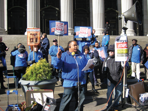 Photo by Dusica Sue Malesevic Jonathan Smith, president of the New York Metro Area Postal Union, rallies the crowd and lead chants such as “We are the 99 percent.” 