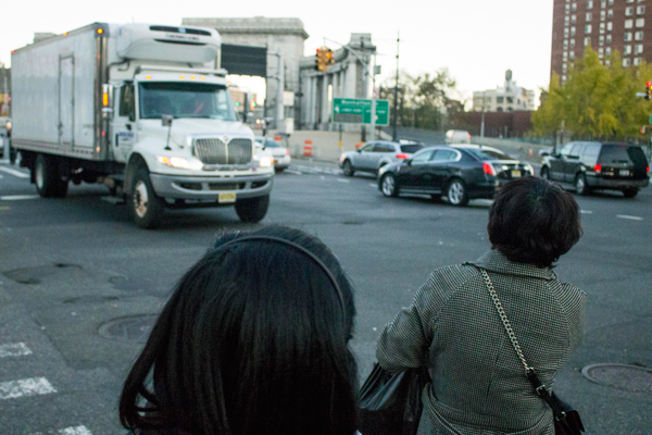 Downtown Express photos by Zach Williams  Pedestrians try and cross at Canal St. and Bowery, near the entrance to the Manhattan Bridge.