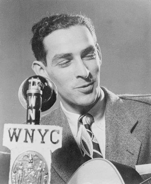 Oscar Brand strumming his guitar and singing on air on WNYC circa 1940s