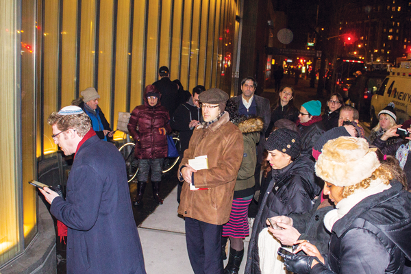 Photos by Zach Williams Chelsea Film Festival co-founder Ingrid Jean Baptiste (right foreground) joined a prayer outside after a memorial reached full occupancy on Jan. 11.