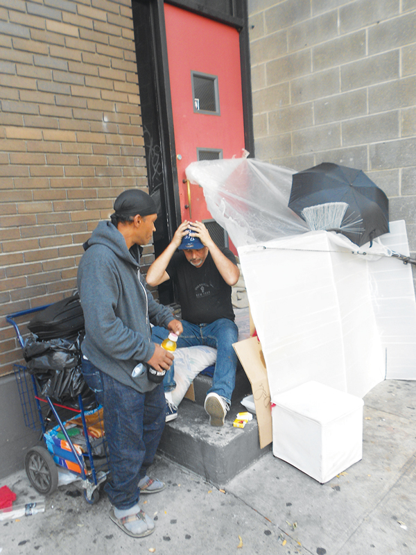 Jon Bivona, right, and another homeless man camped out next to the Church of the Nativity, on Second Ave.