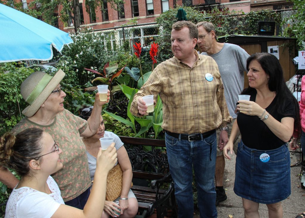 Dennis Gault and Terri Cude, right, the new Democratic district leaders of Part B of the 66th Assembly District, toasted their victory Sept. 13 in the LaGuardia Corner gardens. Downtown Express photo by Tequila Minsky.