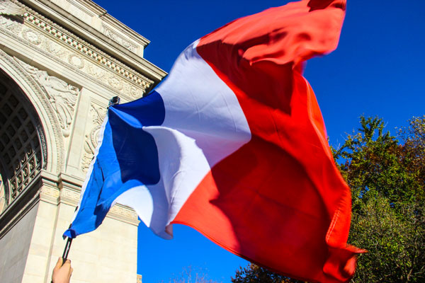 Photo by tequila minsky The Tricolor, the French flag, proudly flew by the arch.