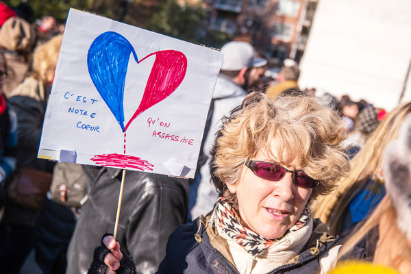 Photo by milo hess “It’s our heart being murdered,” read a woman’s sign at the vigil.