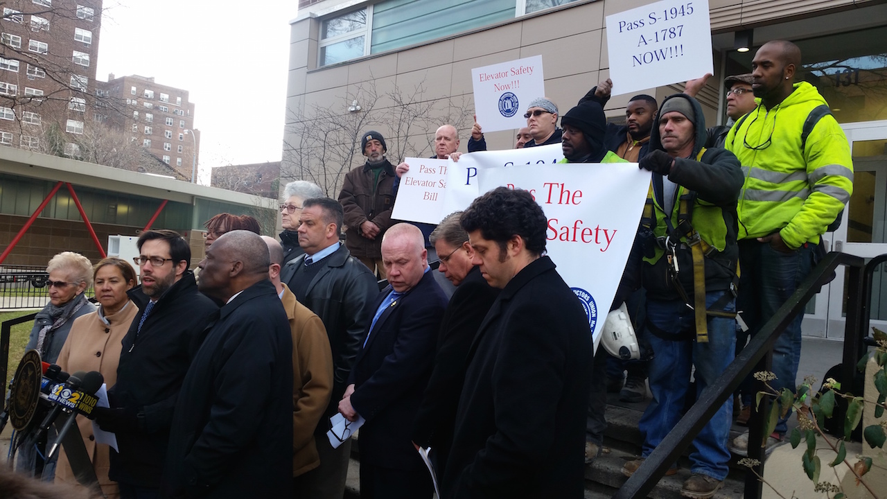 At a press conference last week at the Grand St. Guild houses, state Senator Daniel Squadron, speaking at microphone, Assemblymember Keith Wright, to the right of him, tenant leaders and union members said it’s high time that the state Senate pass a stalled bill on elevator safety.