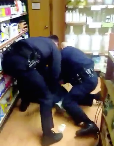 Police handcuff a customer before removing him from the LifeThyme store on Jan. 29. According to store employees, the man insisted on being given a scissor, started cursing and then went behind a counter, scaring a cashier, causing them to call police for assistance.