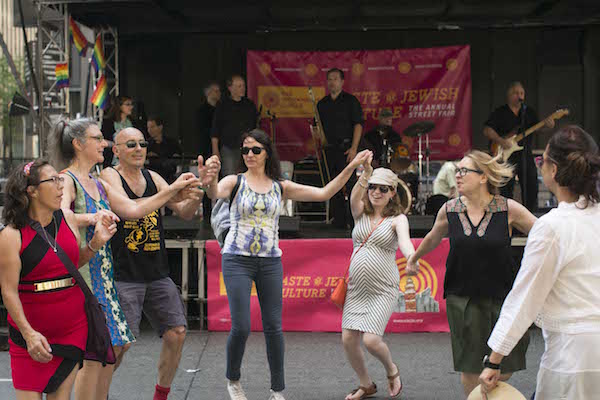 The Workmen’s Circle Yiddish teacher Eve Jochnowitz (second from l.) leads impromptu dancing. | THE WORKMEN’S CIRCLE 