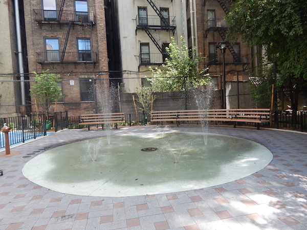 Newly-installed sprinklers in the playground provide relief from the heat. Photo by Jane Argodale.