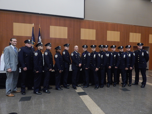 Members of the 10th Precinct, after receiving honors at the June 29 ceremony. In the center is Captain Paul Lanot, their new Commanding Officer. Photo by Jane Argodale.