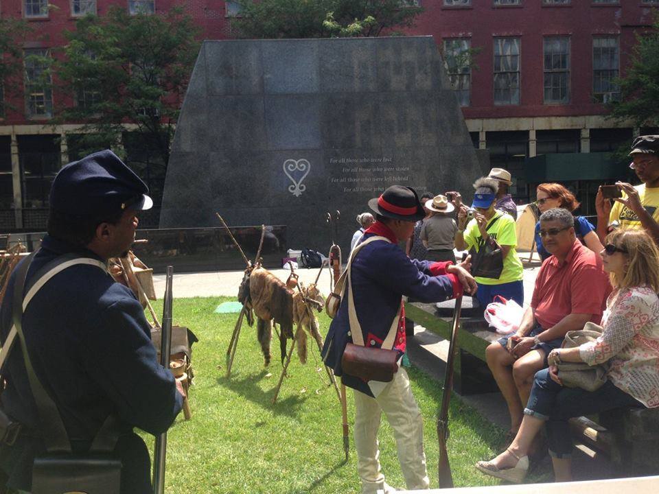 The African of Early New Amsterdam Historical reenactors portraying African-American soldiers from the Revolution to the Civil War conducted educational programs at Downtown's African Burial Ground to mark the official end of slavery in New York State on the Fourth of July in 1827.