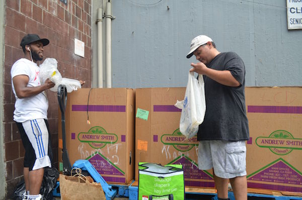 Event staffer Martin Bowrin, left, and LESEC Warehouse Logistics Manager Noel Gonzalez sorting through some of the electronics dropped off at their collection event. Photo by Alex Ellefson.