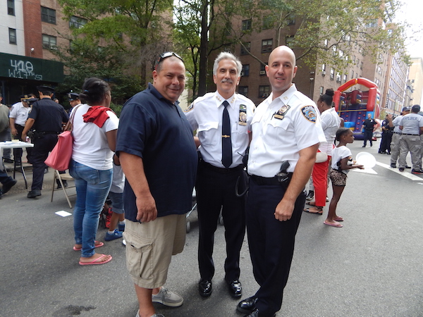 L to R: Detective Mike Petrillo, NYPD Chief of Personnel Raymond Spinella, and new 10th Precinct Commanding Officer Paul Lanot attending the Night Out Against Crime event in Chelsea's Fulton Houses. Photo by Jane Argodale.