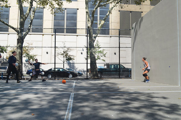 Edgar Fox, far left, and Alfred Kwon hurl balls at teammate Josh Halpenny-Nguyen in preparation for a national dodgeball tournament. Photo by Alex Ellefson.