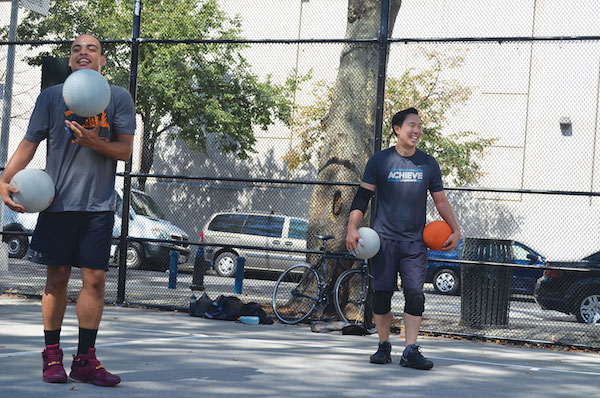 Dodgeball teammates Louis Velez, left, and Alfred Kwon share some laughs on the courts. Photo by Alex Ellefson. 