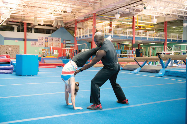 Randy Dorleans works with a student at an adult class at Chelsea Piers. Photo by Scott McDermott 