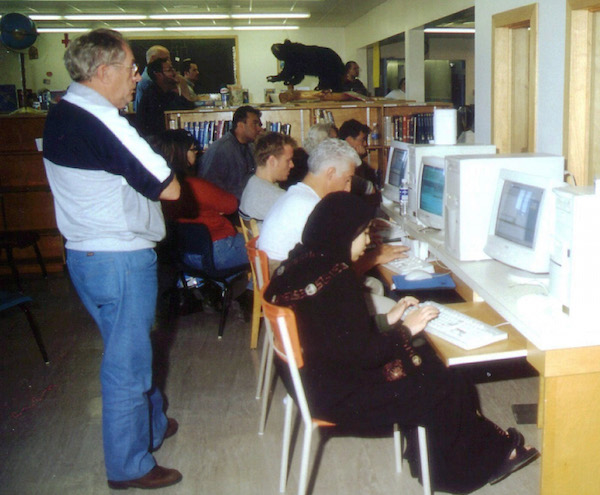 In this Sept. 13, 2001 photo, stranded passengers take turns on computers at Gander Academy, an elementary school in Gander, Newfoundland, Canada to communicate with their families. AP/The Canadian Press photo by Scott Cook. 