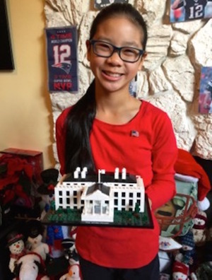 Alena Mulhern holding a model of the White House, her dreamed-of future residence. Photo by Barbara Caparell.