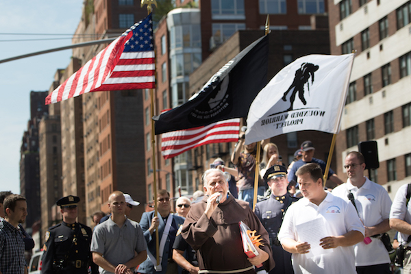 Father Chris Keegan asks for a moment of remembrance for the victims of the 9/11 attacks. Photo by Daniel Kwak.