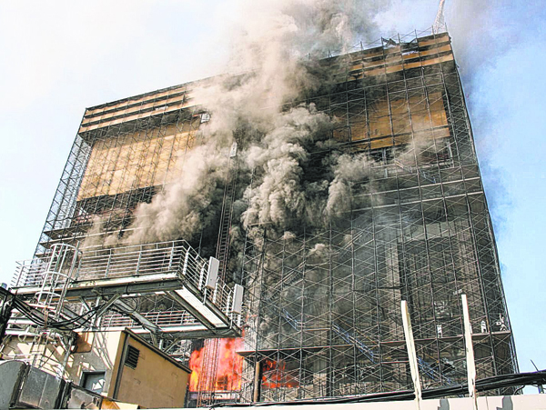 Associated Press / Eric M. Hazard The catastrophic fire at the former Deutsche Bank building on Aug. 18, 2007, killed firefighters Joseph Graffagnino and Robert Beddia, and injured 115 others, in large part because of illegal conditions in the building, which Graffagnino’s father — author of “The Fix Is In” — blames on the shady contractors and political appointees who rushed the demolition job. 