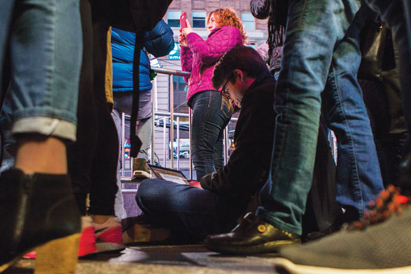 A French journalist works on an article as he waits for election results in Times Square on Tuesday night. Photo by Zach Williams.