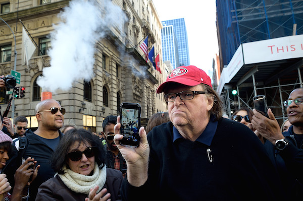 Filmmaker and activist Michael Moore, here filming with his phone, was among Saturday’s demonstrators. Photo by Donna Aceto.