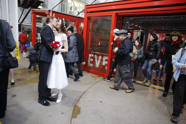 Passersby look on in approval, after the wedding ceremony. Photo by Jenny MacFarlane/stylishhipweddings.com.