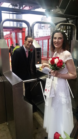 Get me to the tram on time: Jennifer uses her MetroCard to start life with Wesley, who has already paid his fare. Photo by Kimberly Kovach Allen.