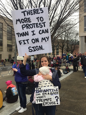 Ann Grant, a public defender in Massachusetts, felt it was time for her infant daughter Vivian to begin doing her civic duty. Vivian's poster says it all. Photo by David Puchkoff.