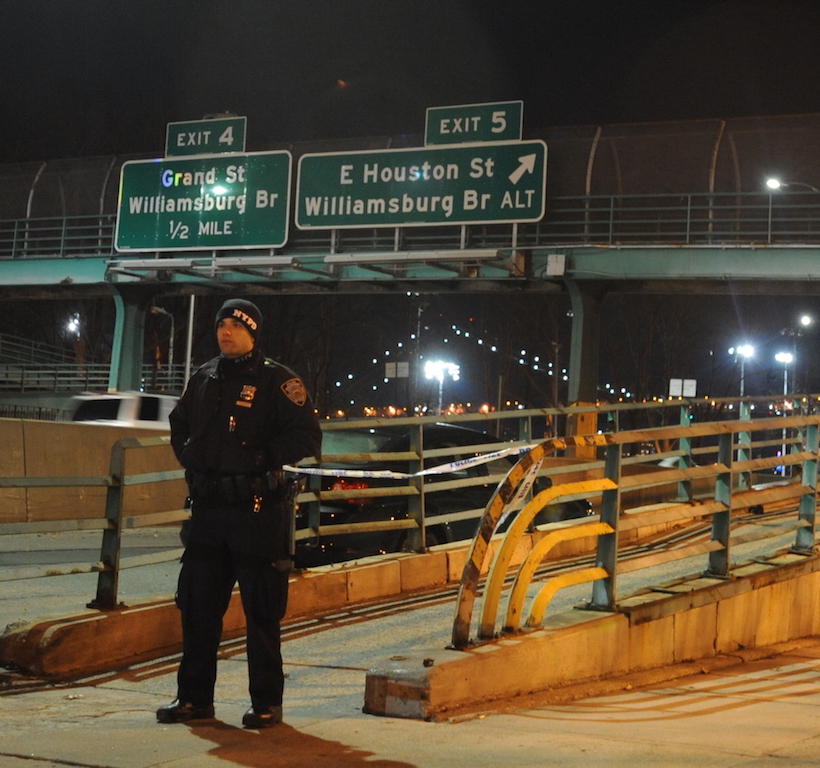 A police officer secured the entrance to the E. Sixth St. pedestrian bridge over the F.D.R. Drive early Thursday morning. An unidentified male was shot on the east end of the bridge, police said. The victim was removed to a local hospital in an unknown condition. Photo by C4P